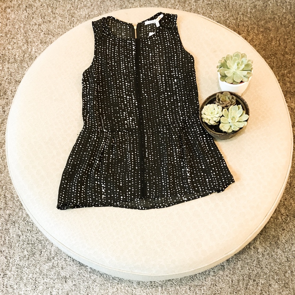 Black and white sleeveless peplum top